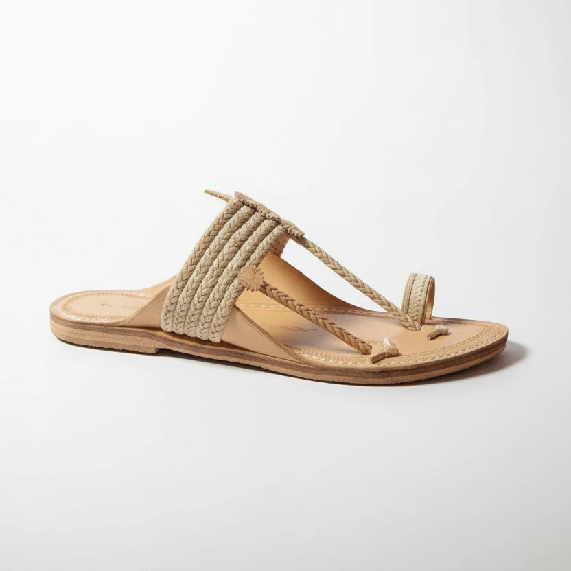 Beige sandal with braided design on a light gray background