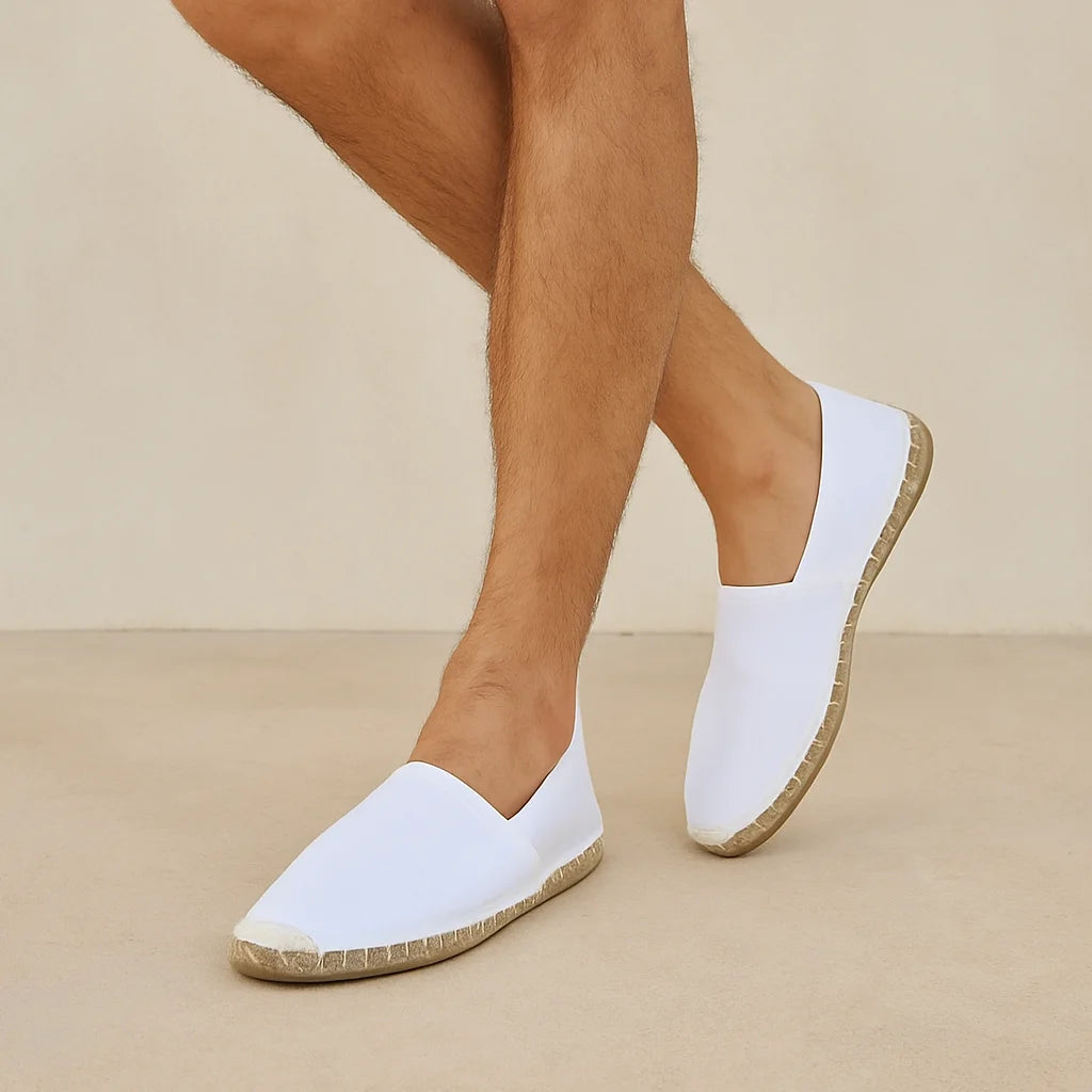 White slip-on shoes with cork soles worn by a person on a beige background
