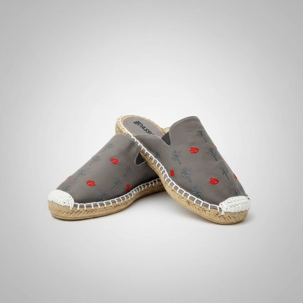 Gray slip-on shoe with floral embroidery on a white background