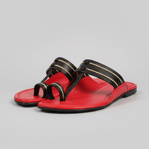 Red and black shoe rack on a wooden floor with a blurred background