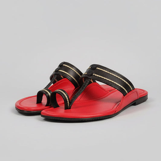 Red and black shoe rack on a wooden floor with a blurred background