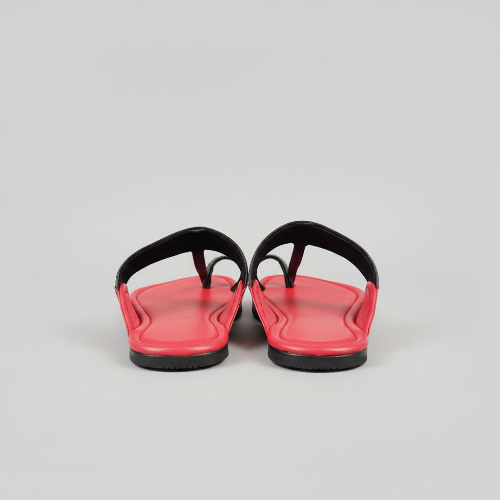 Red shoes on a glass surface with a blurred background