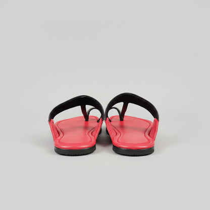 Red shoes on a glass surface with a blurred background