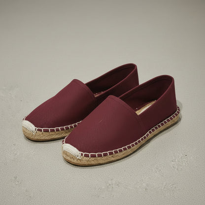 maroon espadrilles with jute sole on a textured surface