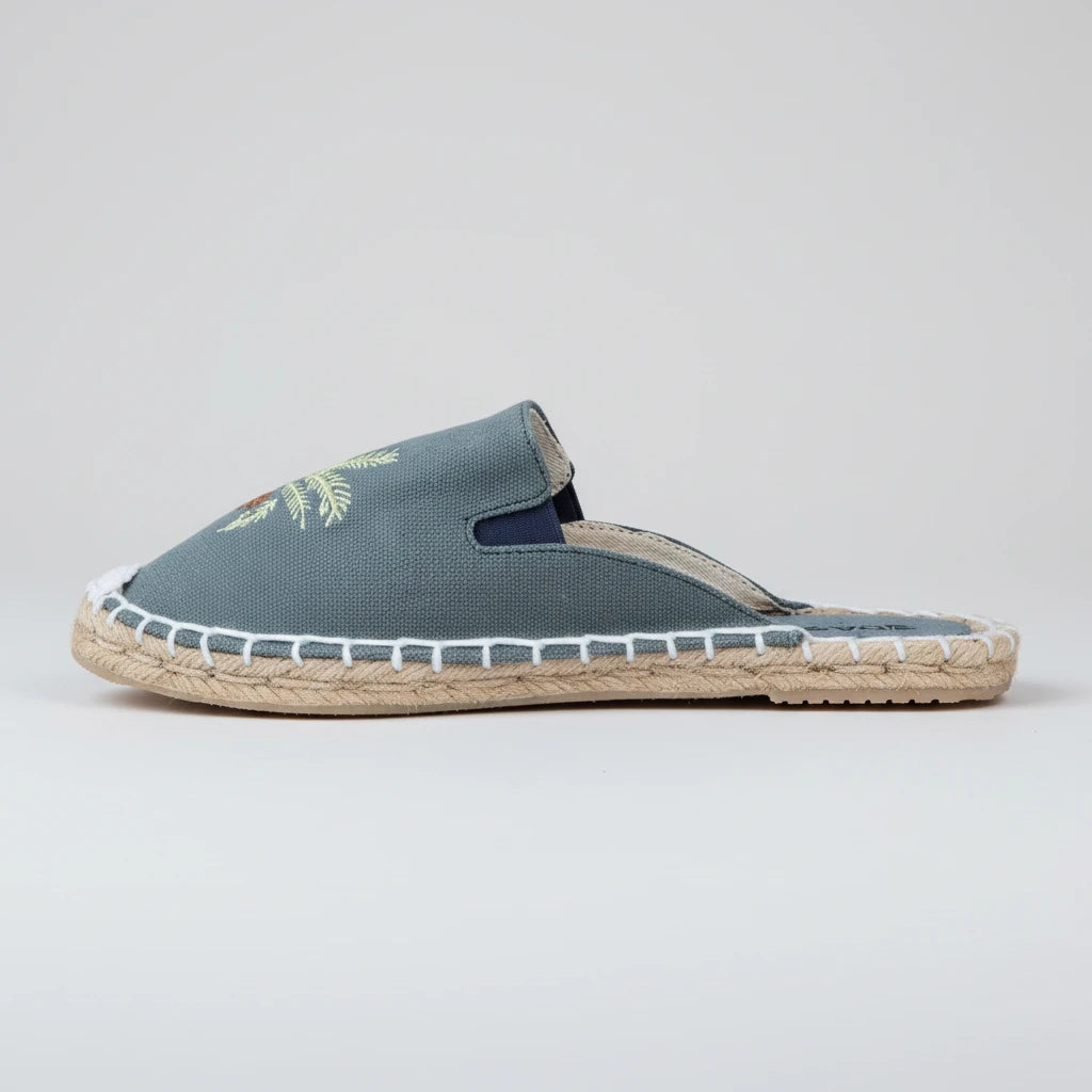 Blue espadrille slipper with jute sole on a white background