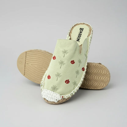 Pair of open-toe shoes with embroidered design on a white background