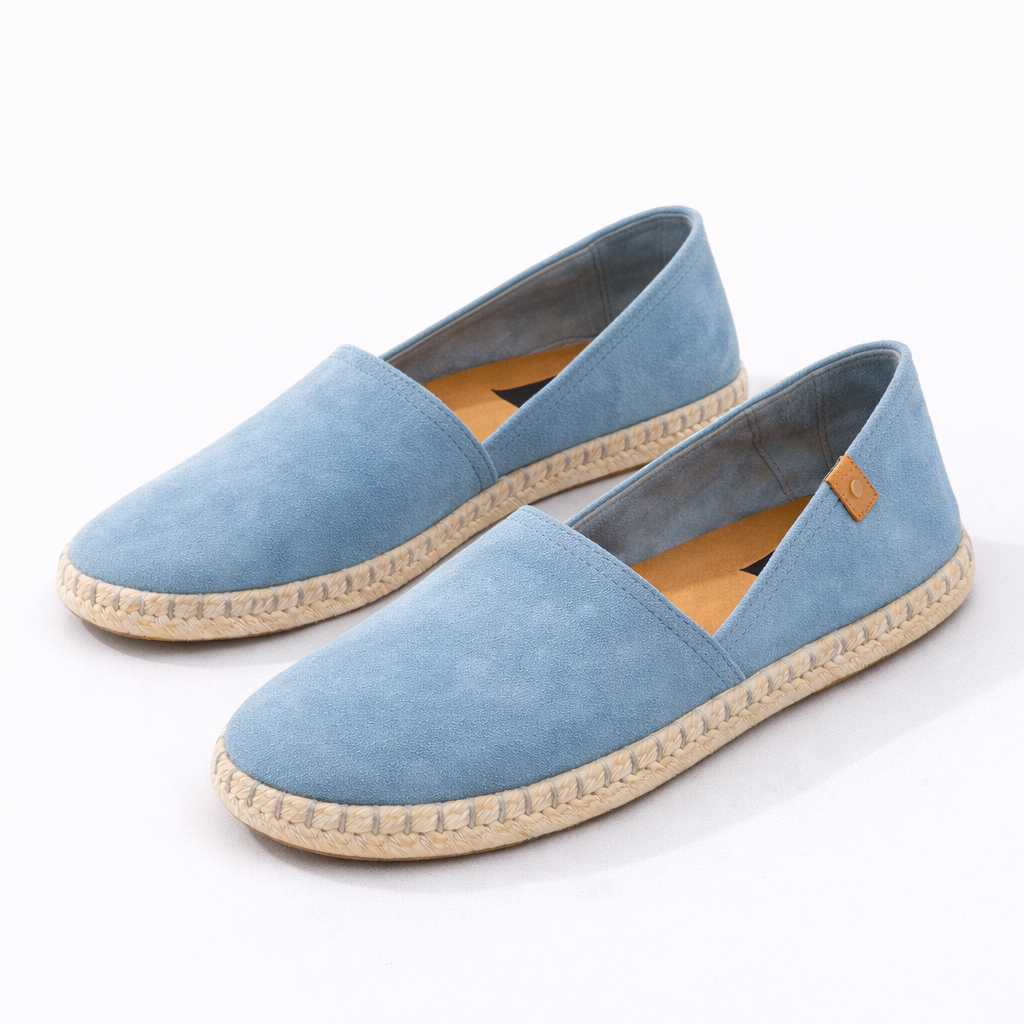 Pair of light blue espadrilles on a white background