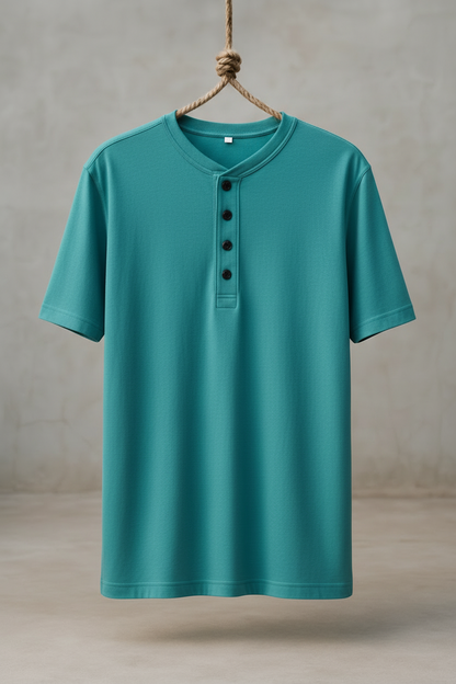 Teal short-sleeve henley shirt hanging on a wooden hook against a neutral background