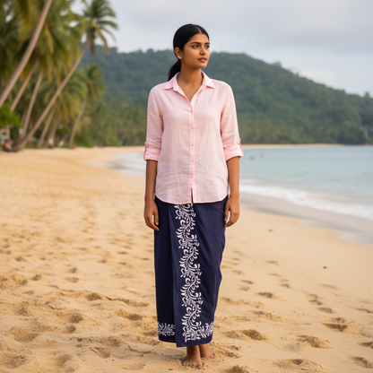 Woman standing on a beach with palm trees and mountains in the background