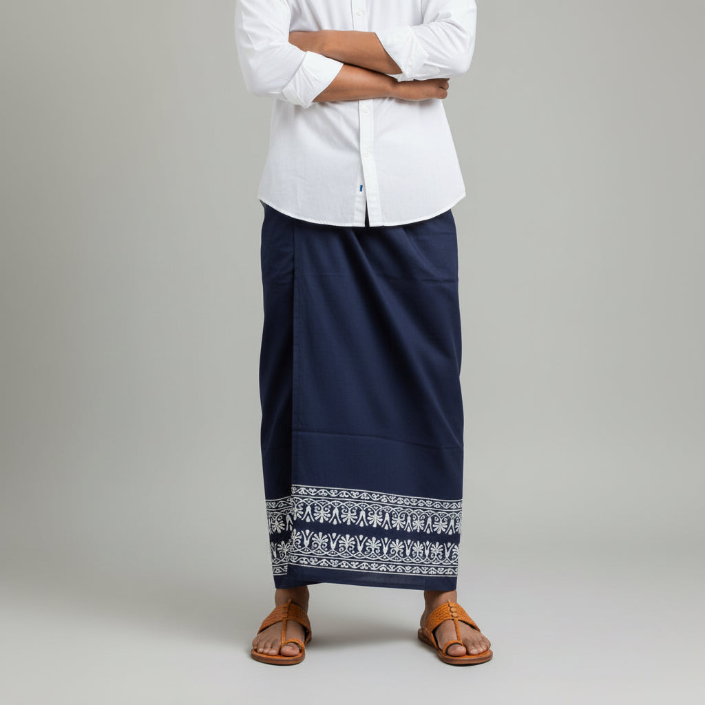 Person wearing a white shirt and navy skirt with elephant patterns on a plain background