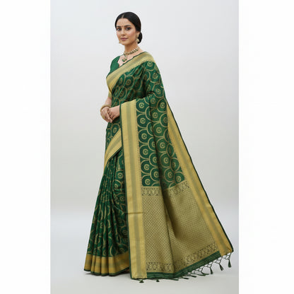 Green and gold saree with intricate patterns, worn by a model and displayed on a table.