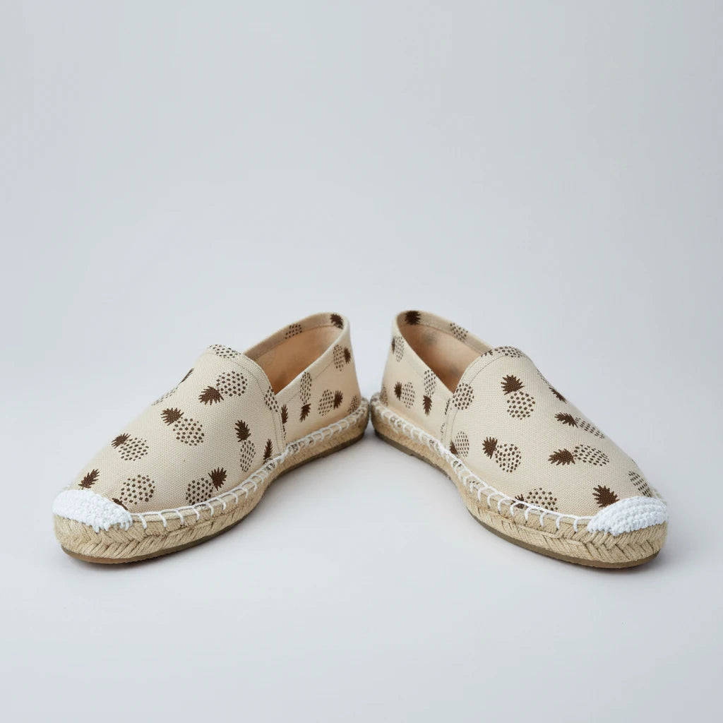 Beige slip-on shoe with pineapple pattern on a white background