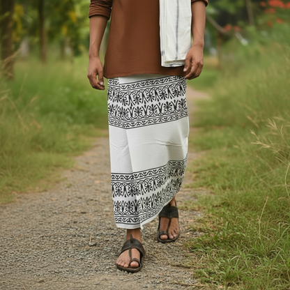 Person wearing a brown top and white pants with black patterns outdoors.