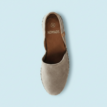 Beige shoe with 'Nomads' branding on a white background