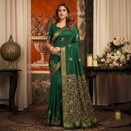 Woman wearing a green saree with floral patterns in an indoor setting.