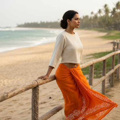 Collage of a woman wearing an orange traditional dhoti/lungi with white patterns in various outdoor settings.