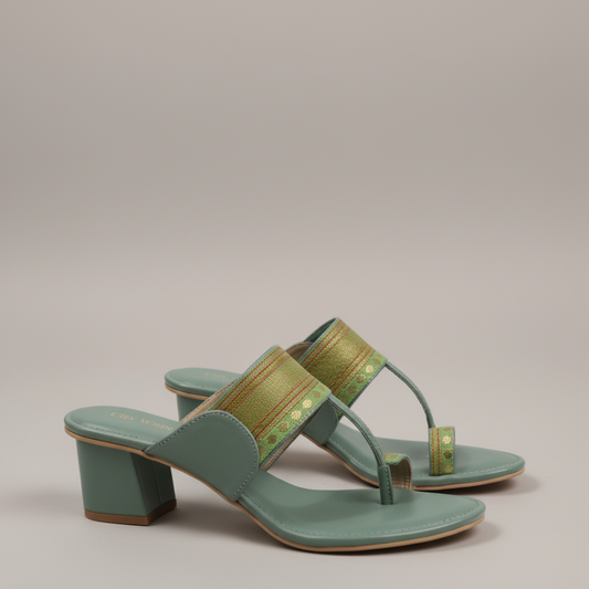 Green sandals on a carpeted floor with a fireplace and chair in the background