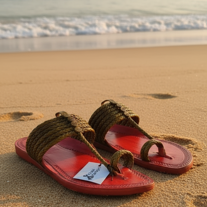 Red sandal with brown rope detailing and a visible brand tag on a blurred background
