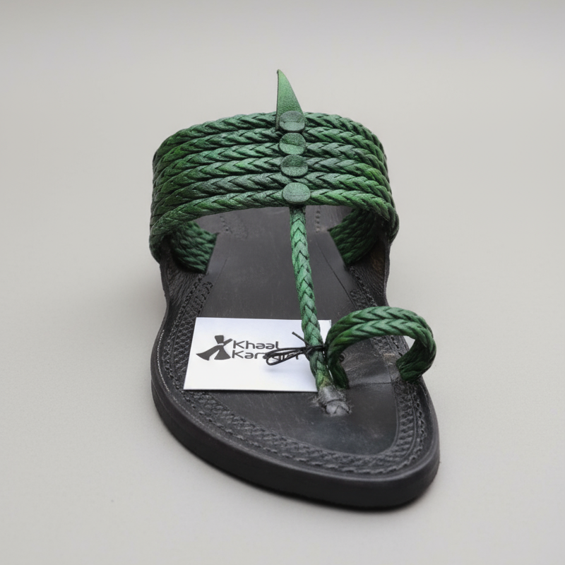 Gray sandal with green braided straps on a light stone surface, featuring Khaal Karagiri branding.