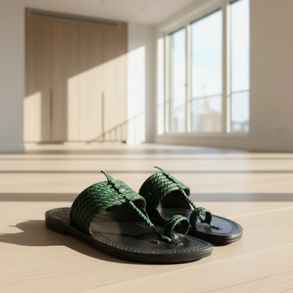 Pair of sandals with green braided straps on a light background