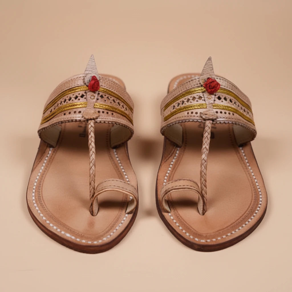 Pair of decorative sandals with floral accents on a beige background