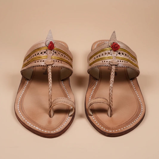 Pair of decorative sandals with floral accents on a beige background