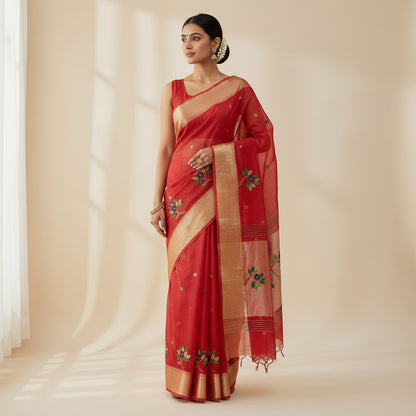 Red blouse with floral embroidery and a gold border on a patterned background