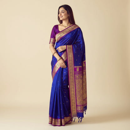 Woman wearing a blue and purple saree with gold patterns, standing in front of a wall clock.