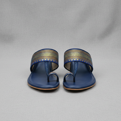 Pair of blue sandals with decorative straps on a white background