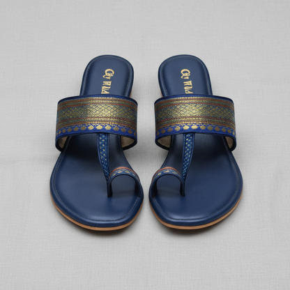 Pair of blue sandals with decorative straps on a white background