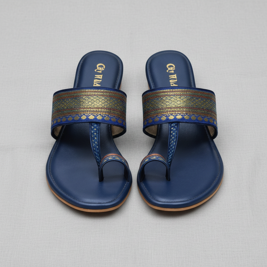 Pair of blue sandals with decorative straps on a white background