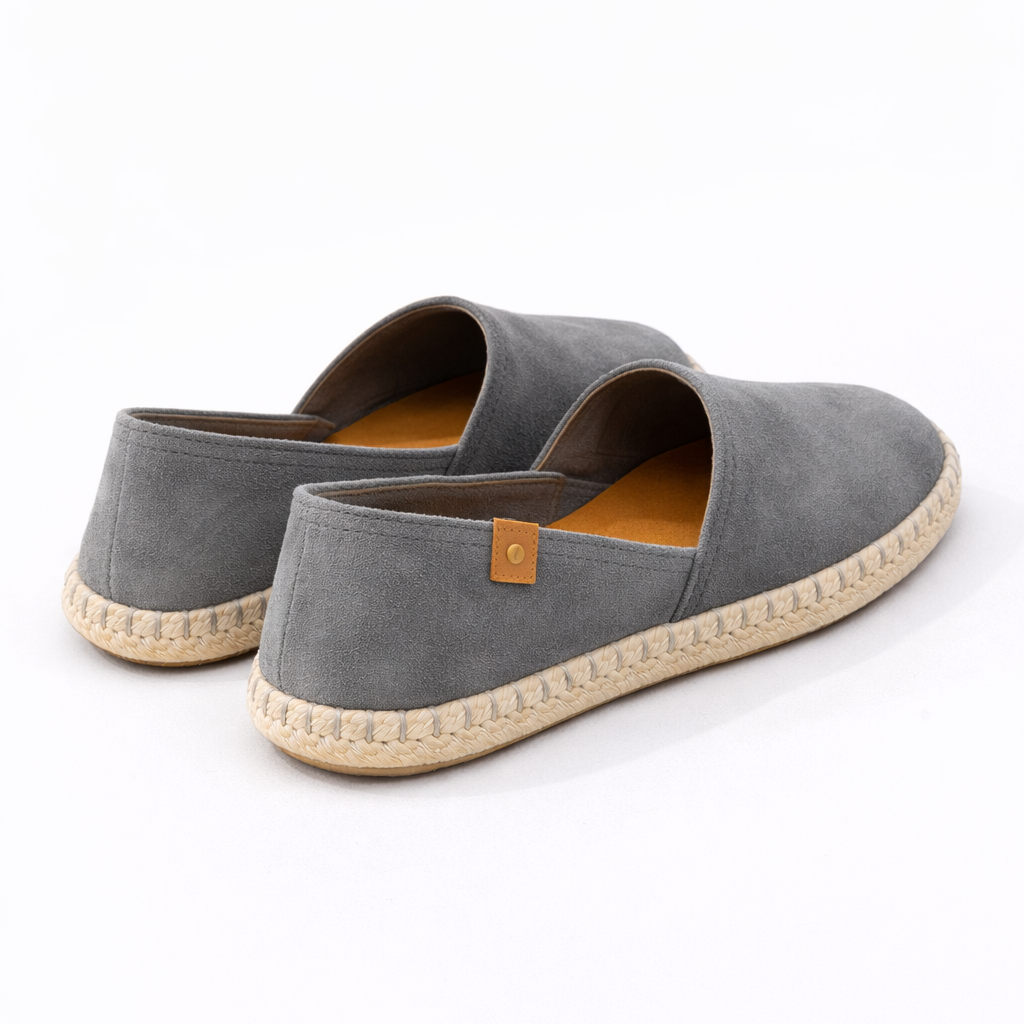 Pair of gray espadrilles on a white background