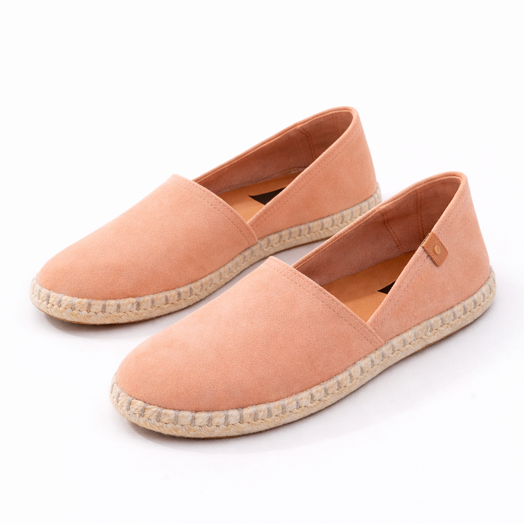 Pair of pink espadrille shoes on a white background