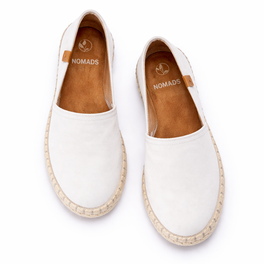 White espadrilles with brown soles on a white background