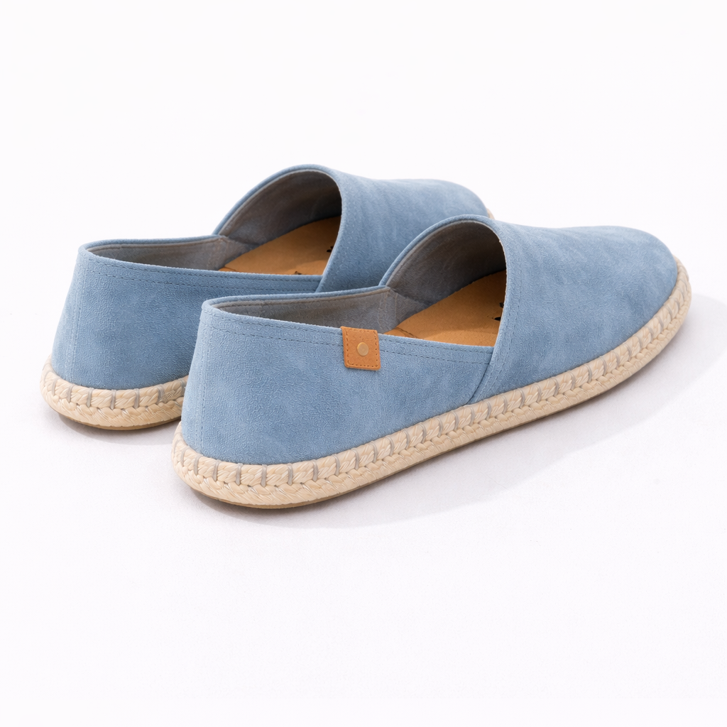 Pair of blue espadrilles on a white background