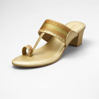 Gold sandal with a decorative strap on a white background