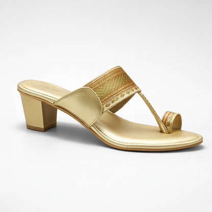 Gold sandal with a block heel on a white background