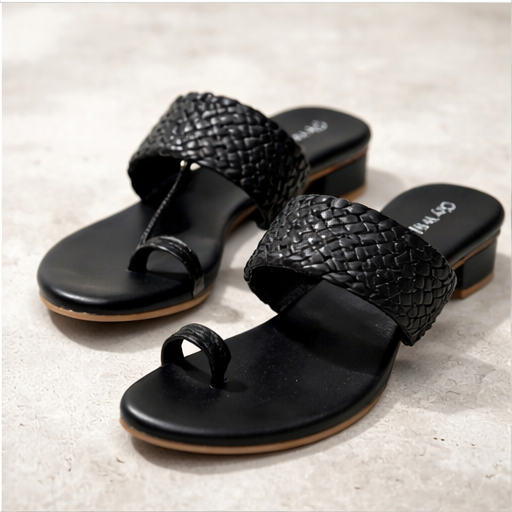 Pair of black woven sandals on a light gray background