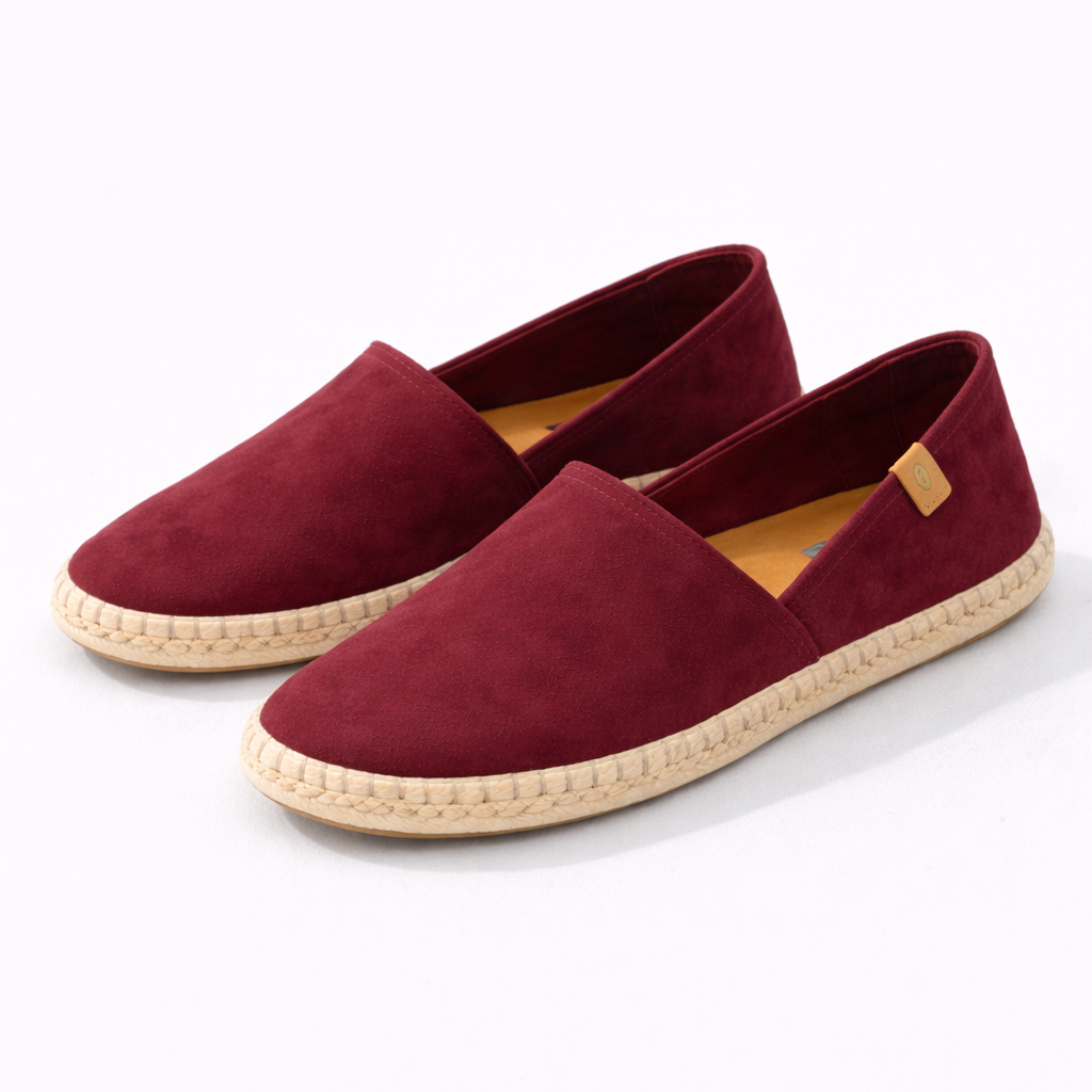 Pair of maroon espadrilles on a white background