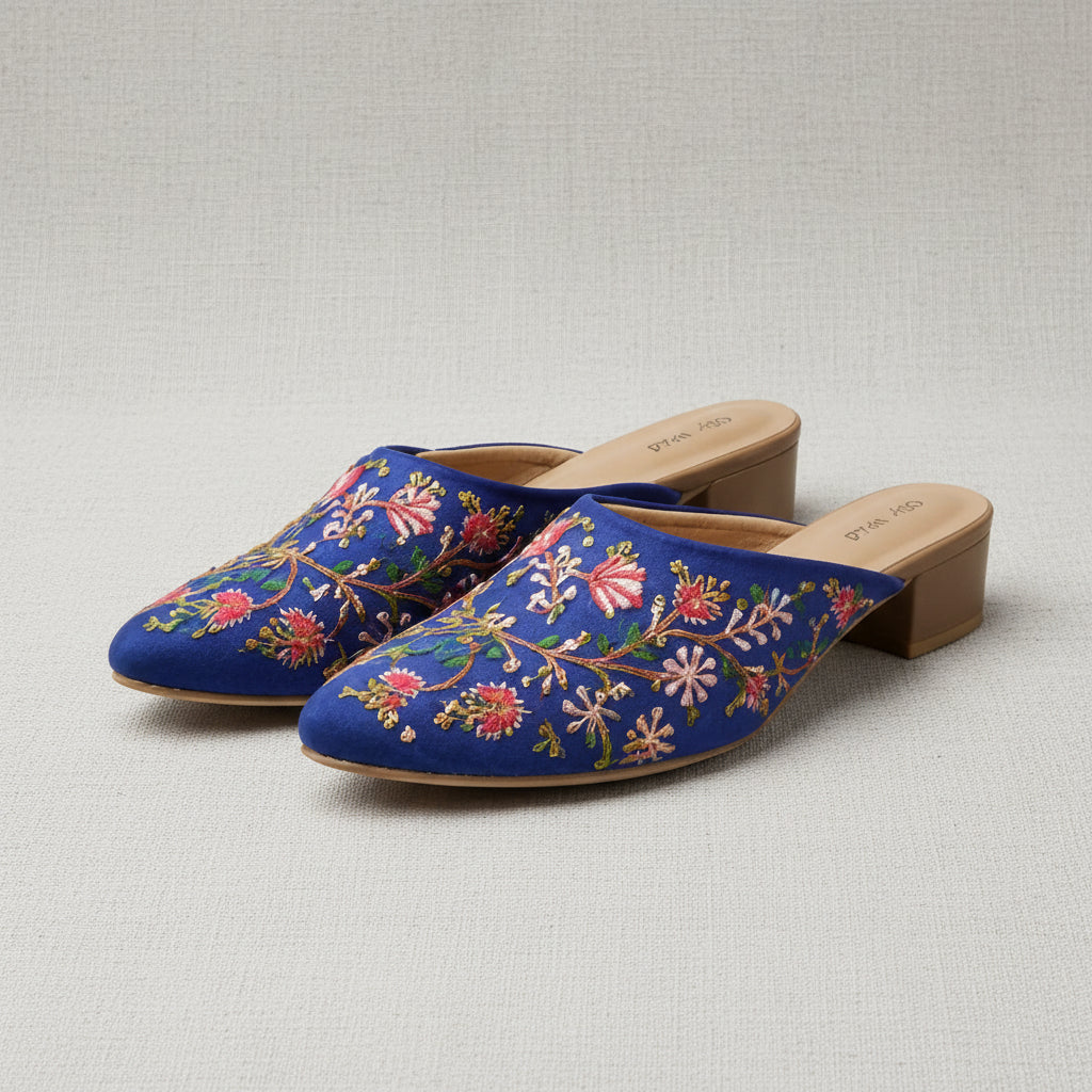 Blue embroidered shoes on a white background