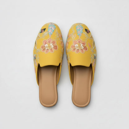 Yellow embroidered slippers on a white background